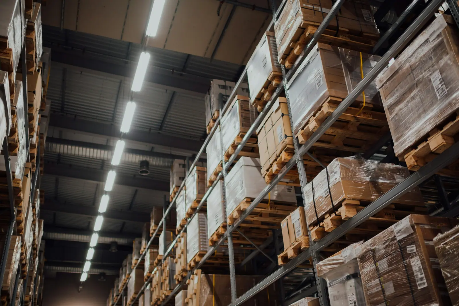 Pallets of boxes on high warehouse racking